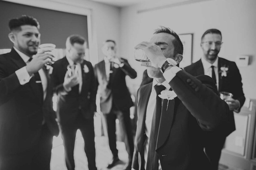 A group of groomsmen drinking a toast