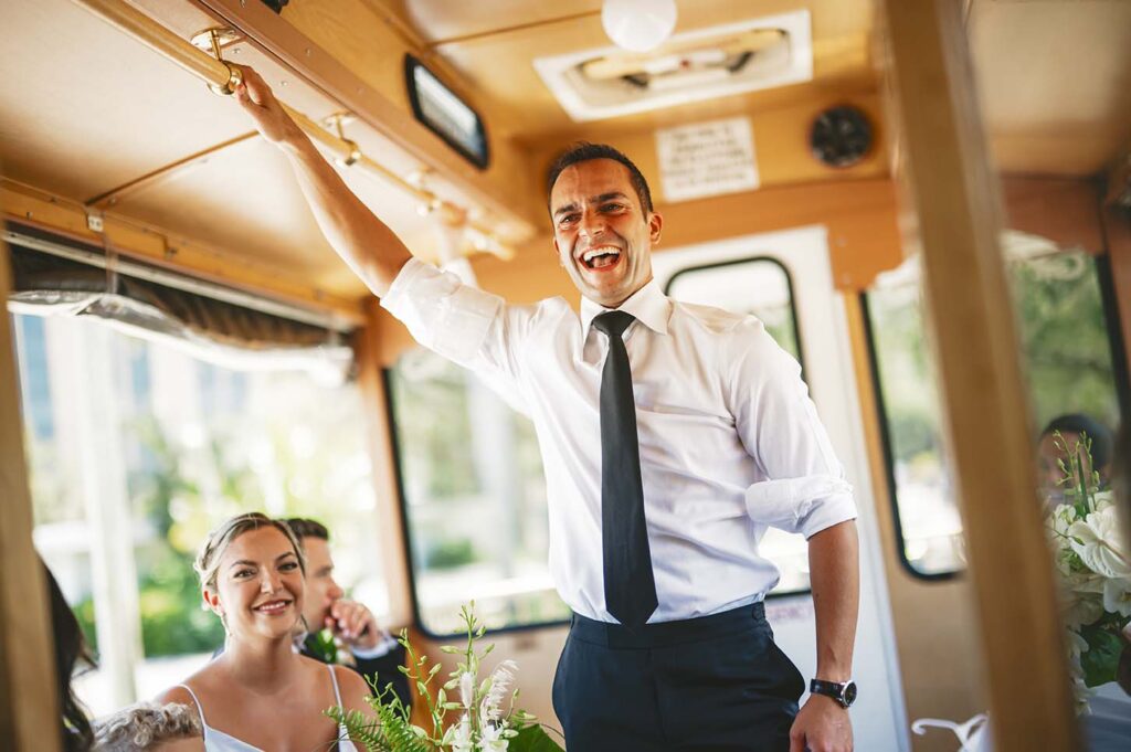 A bride and groom on a trolley at a wedding.